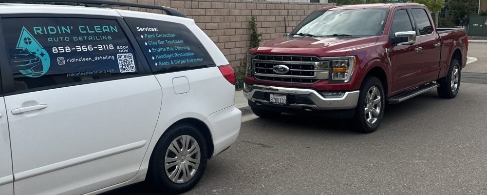 A car from Ridin Clean Auto Detailing next to a Red Ford in San Diego