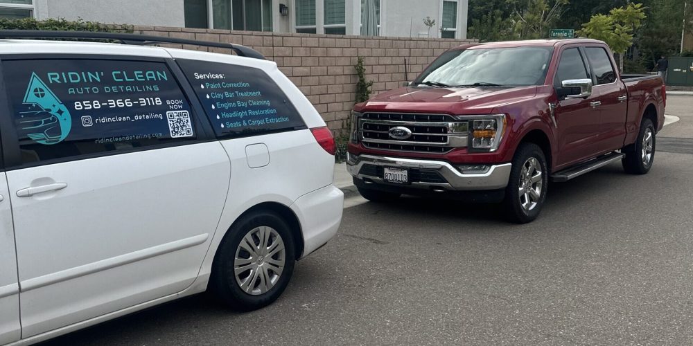 A car from Ridin Clean Auto Detailing next to a Red Ford in San Diego